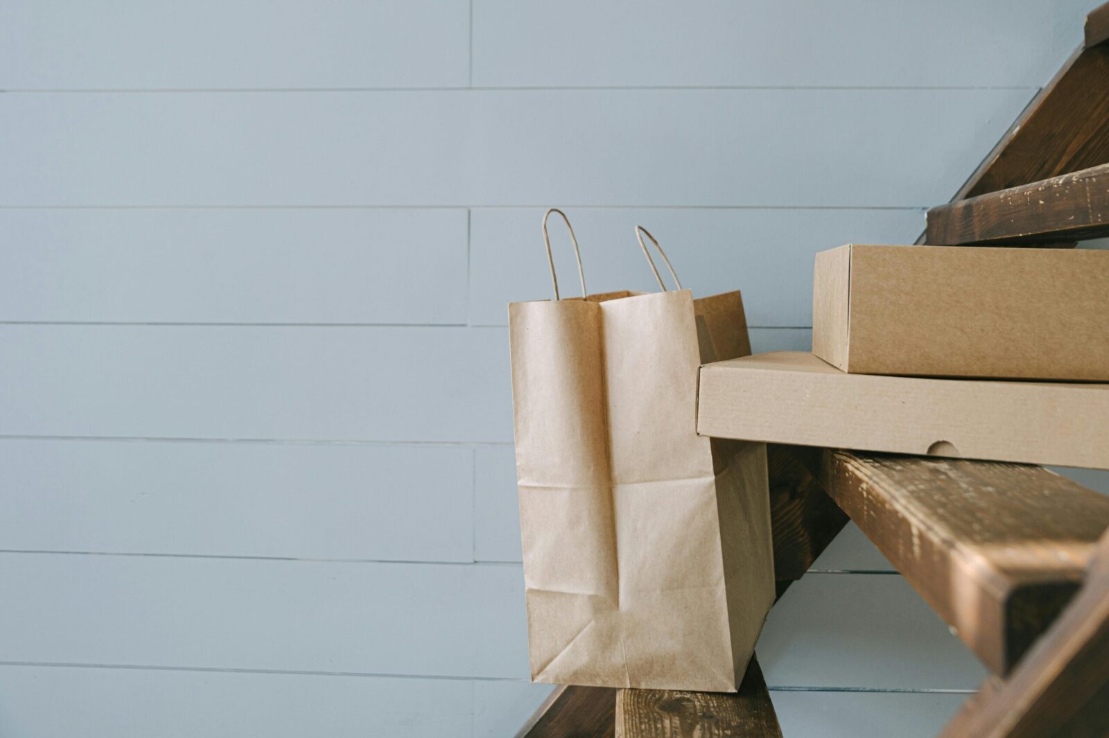 Minimalist image of paper and cardboard packaging on stairs, perfect for e-commerce themes.